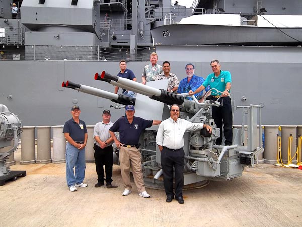 Group posing with the Bofors in front of the USS Missouri battleship at Pearl Harbor — mission accomplished
