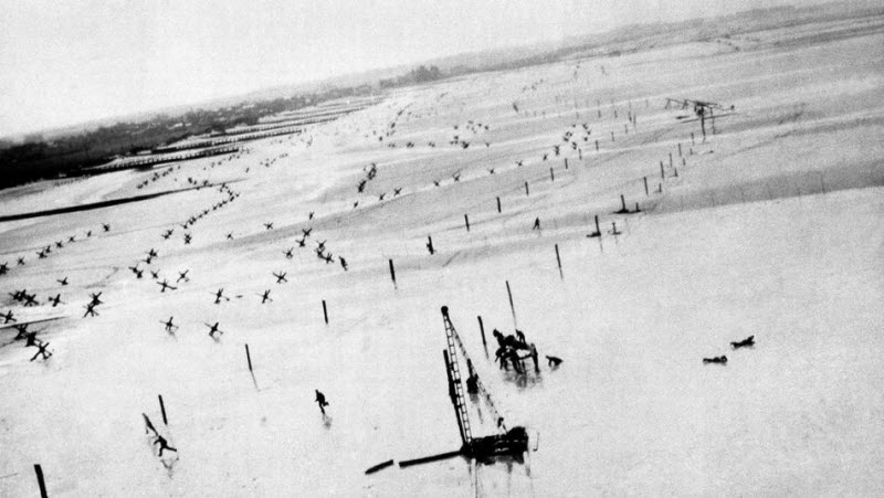 Nazi soldiers rush for shelter from low-flying Allied plane
