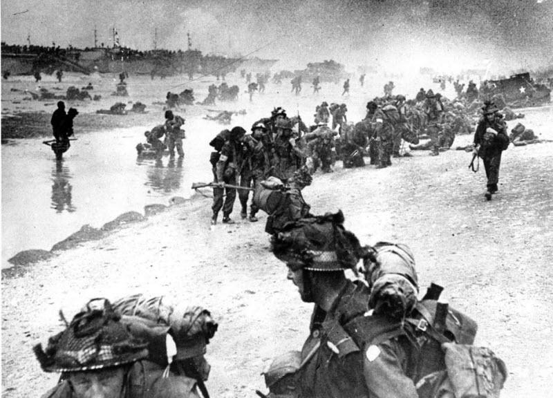 Wounded British troops helped ashore at Sword Beach
