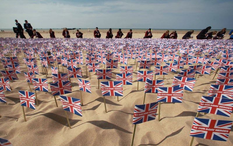 British school children place Union Jack flags on Gold Beach 2009