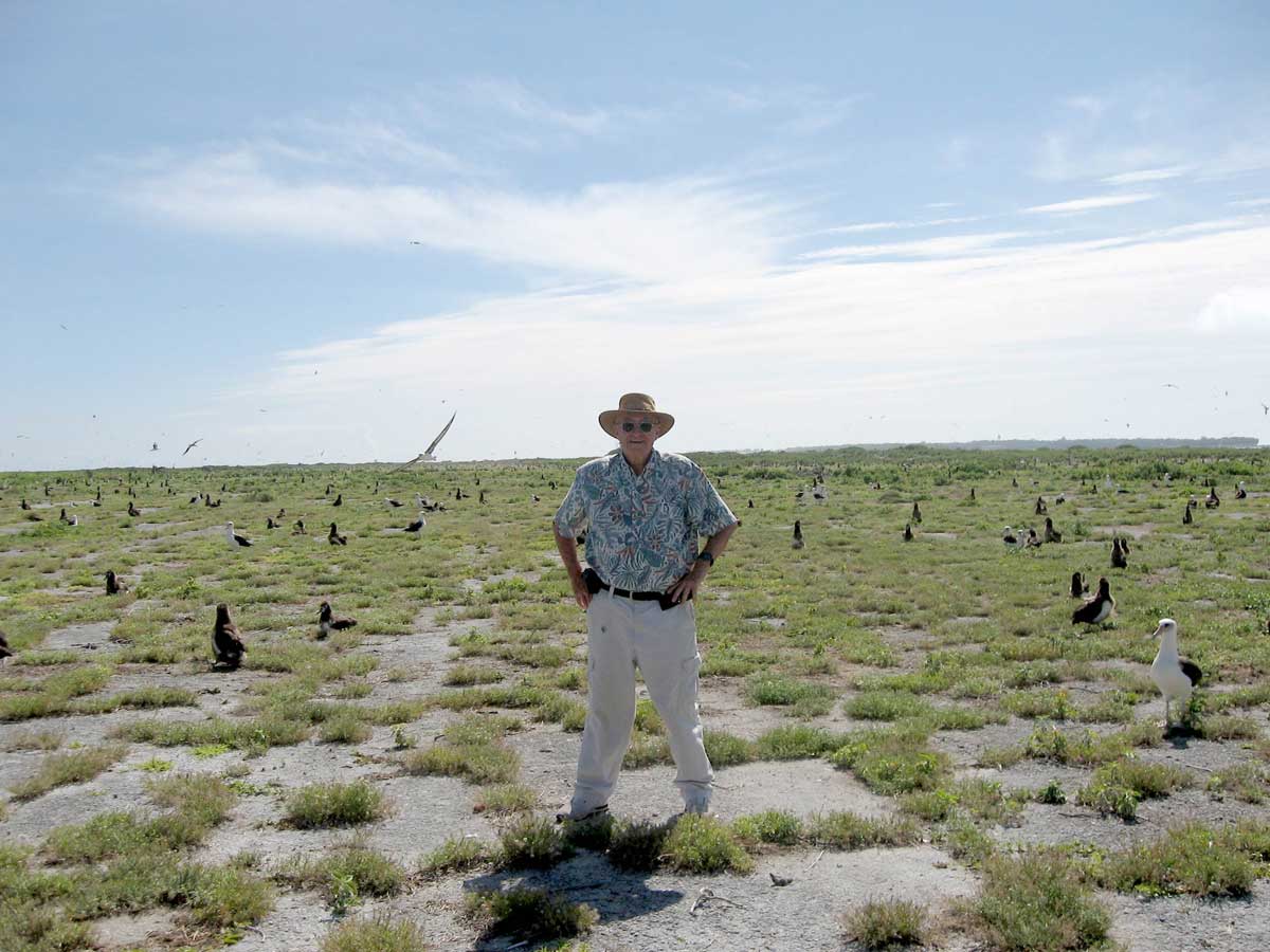Ford Murray posing with gooney birds on Midway Island
