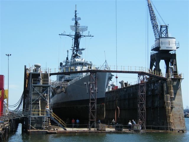 USS Laffey DD-724 drydock — close-up of corroded hull plating along the waterline illustrating why more than 100 holes required patching before the ship could return to display