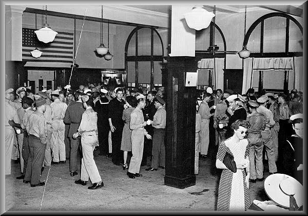 Interior of the North Platte Canteen showing servicemen at the food tables