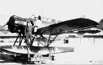 Warrant Officer Nobuo Fujita standing beside his Yokosuka E14Y Glen floatplane before the Oregon bombing mission