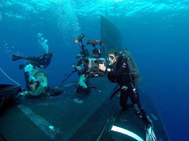 SEALs exiting through the submarine airlock