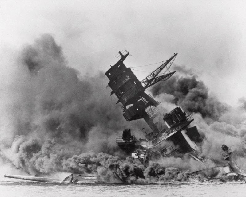 USS Arizona belches smoke as it sinks during Japanese attack on Pearl Harbor
