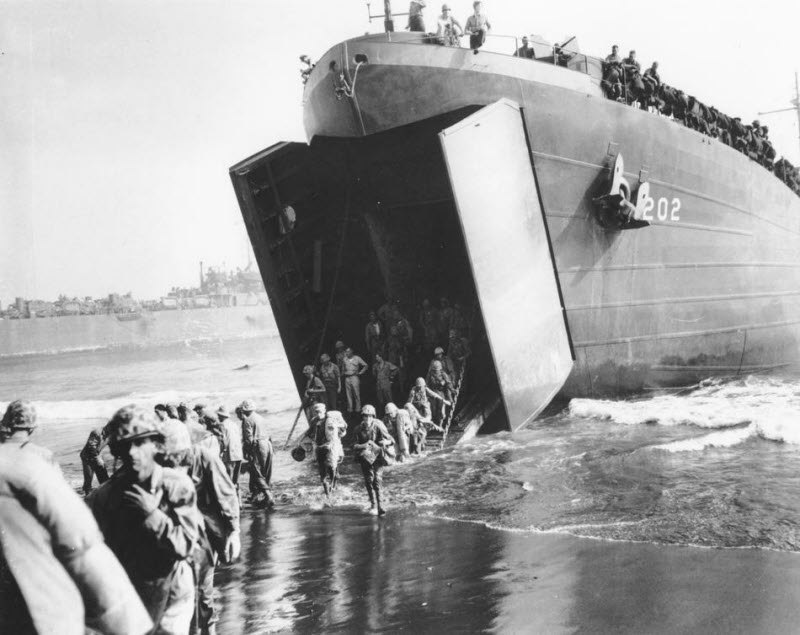 US Marines come ashore from Coast Guard LST at Cape Gloucester New Britain January 1944